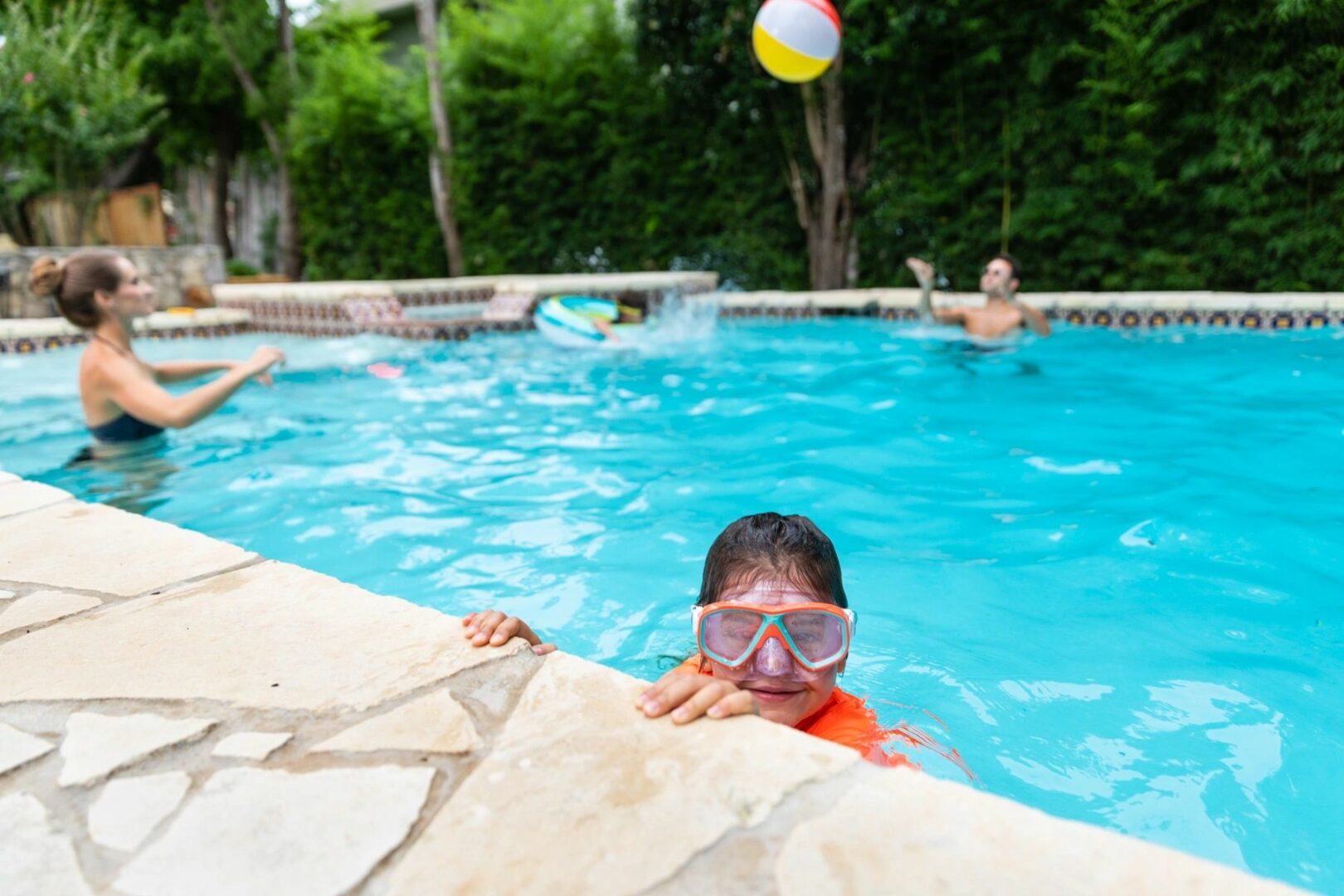 A boy in the pool with goggles on