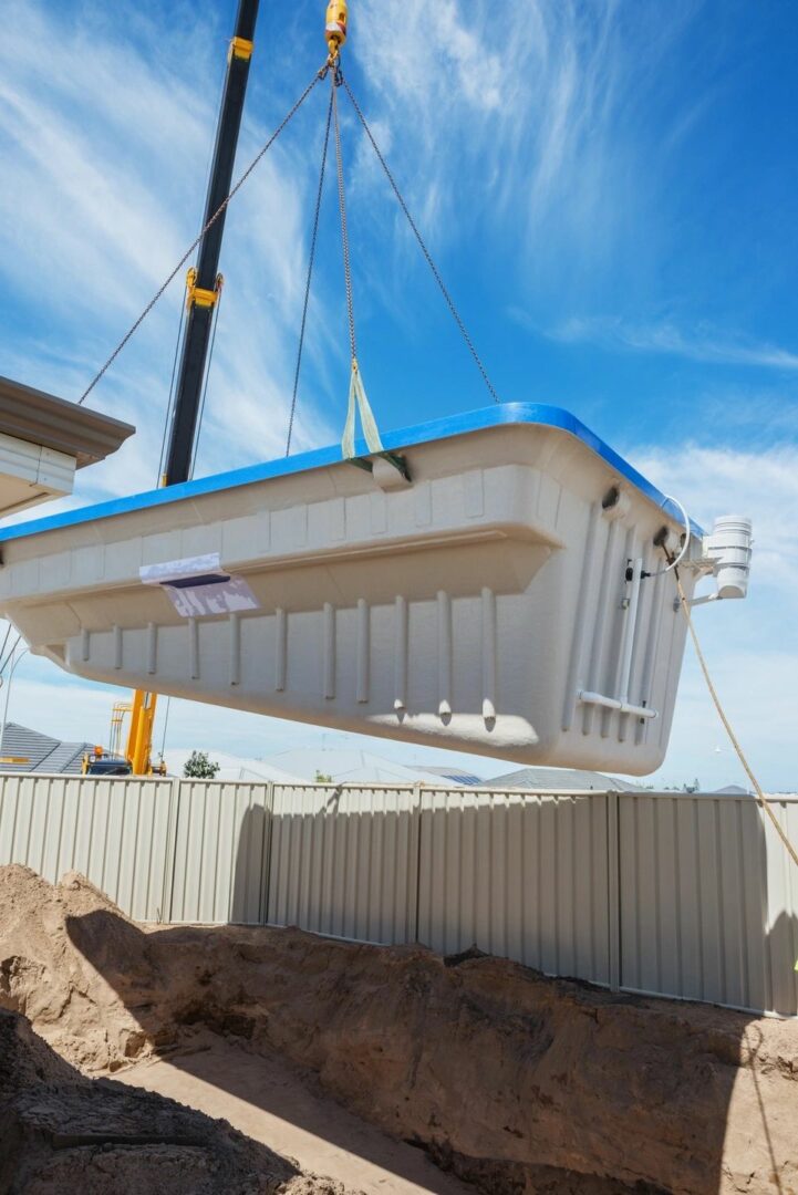 A crane lifting a large white container.